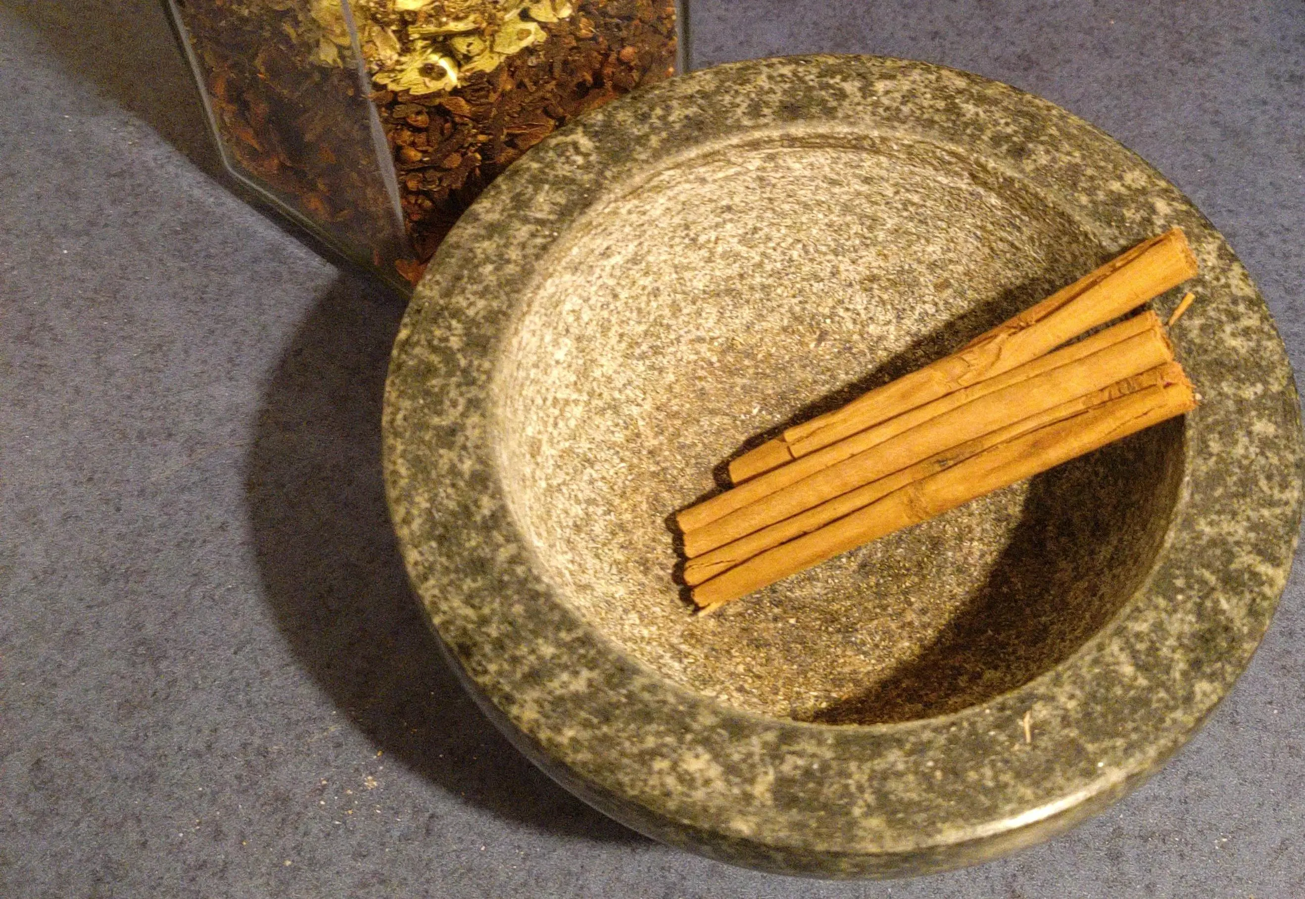 cinnamon sticks in a mortar