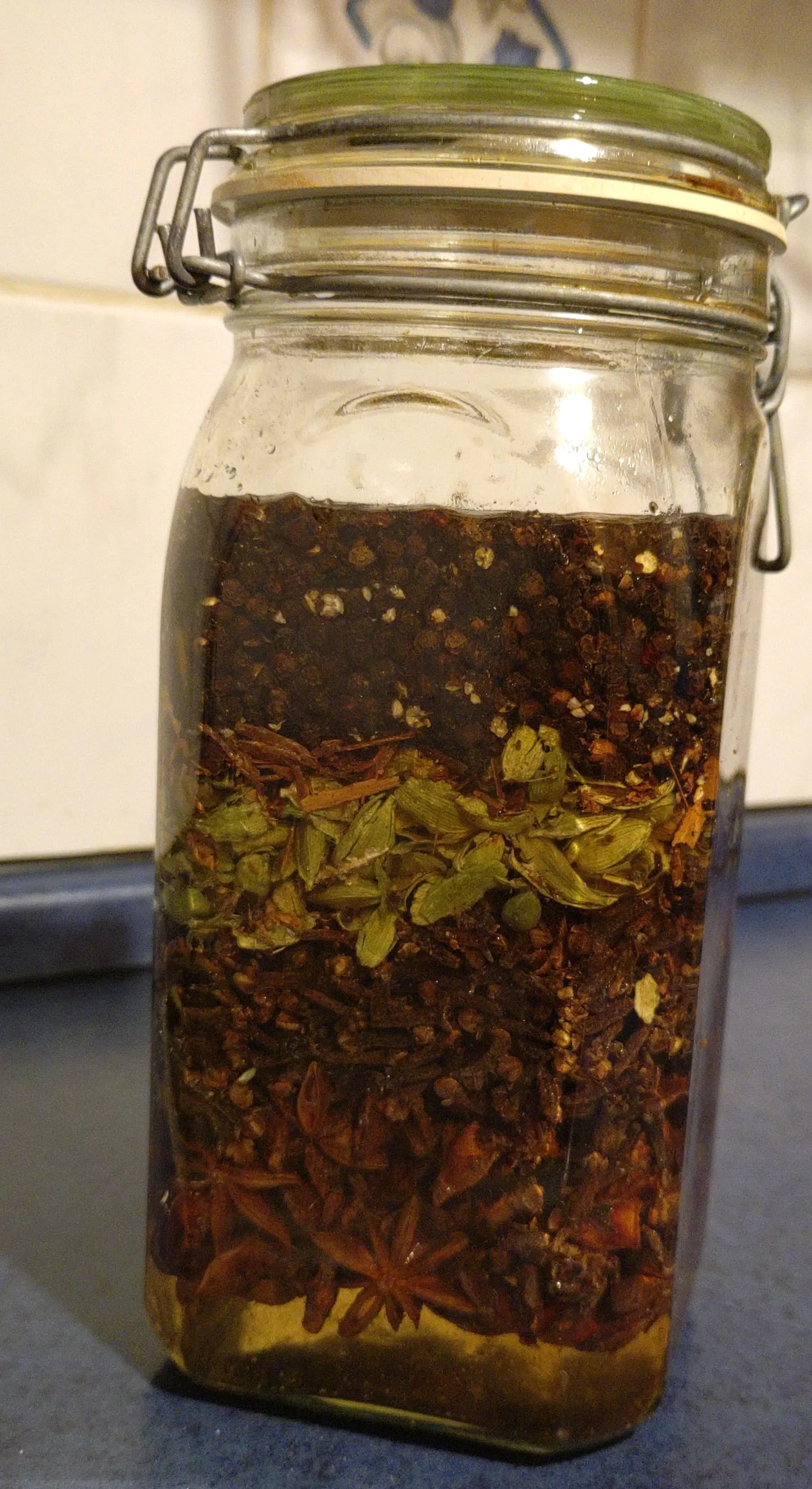 herb layers in a mason jar with gylcerin and water mixture