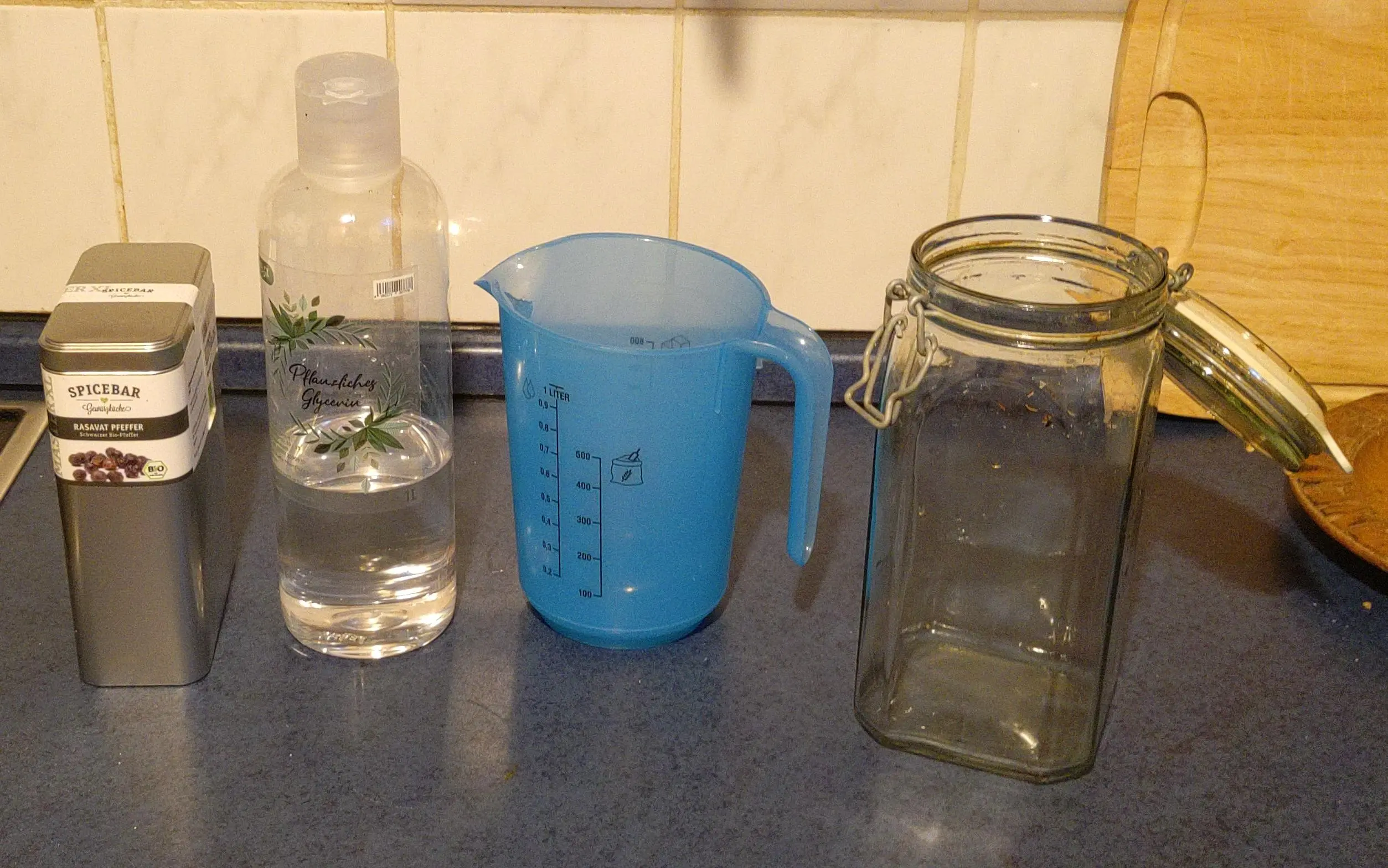 pepper corn tin, glycerin bottle, measuring cup, and a mason jar