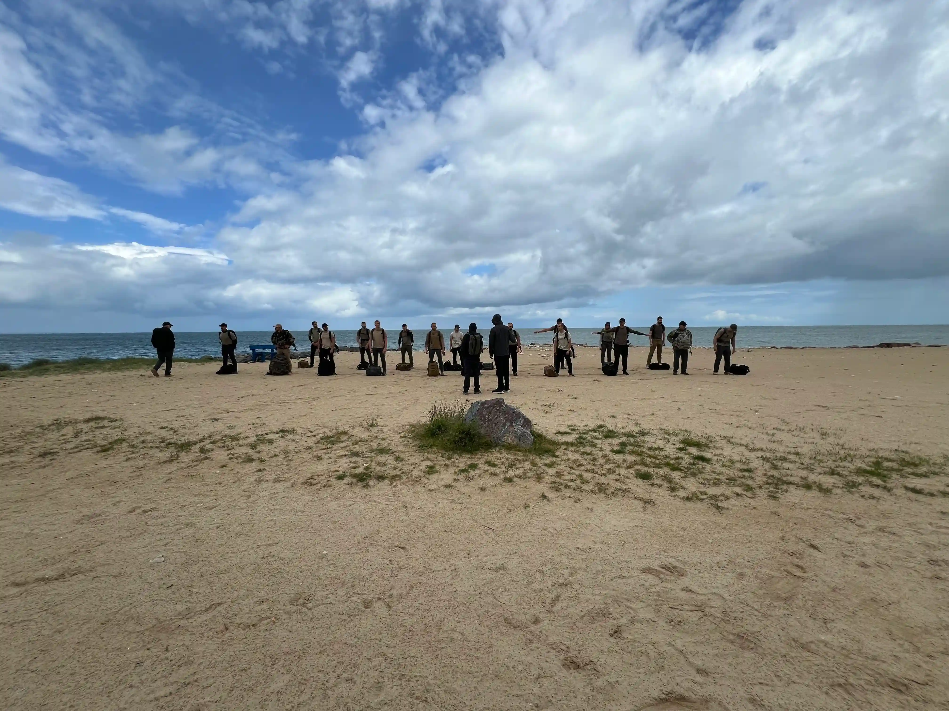 21 candidates line up in formation on the beach