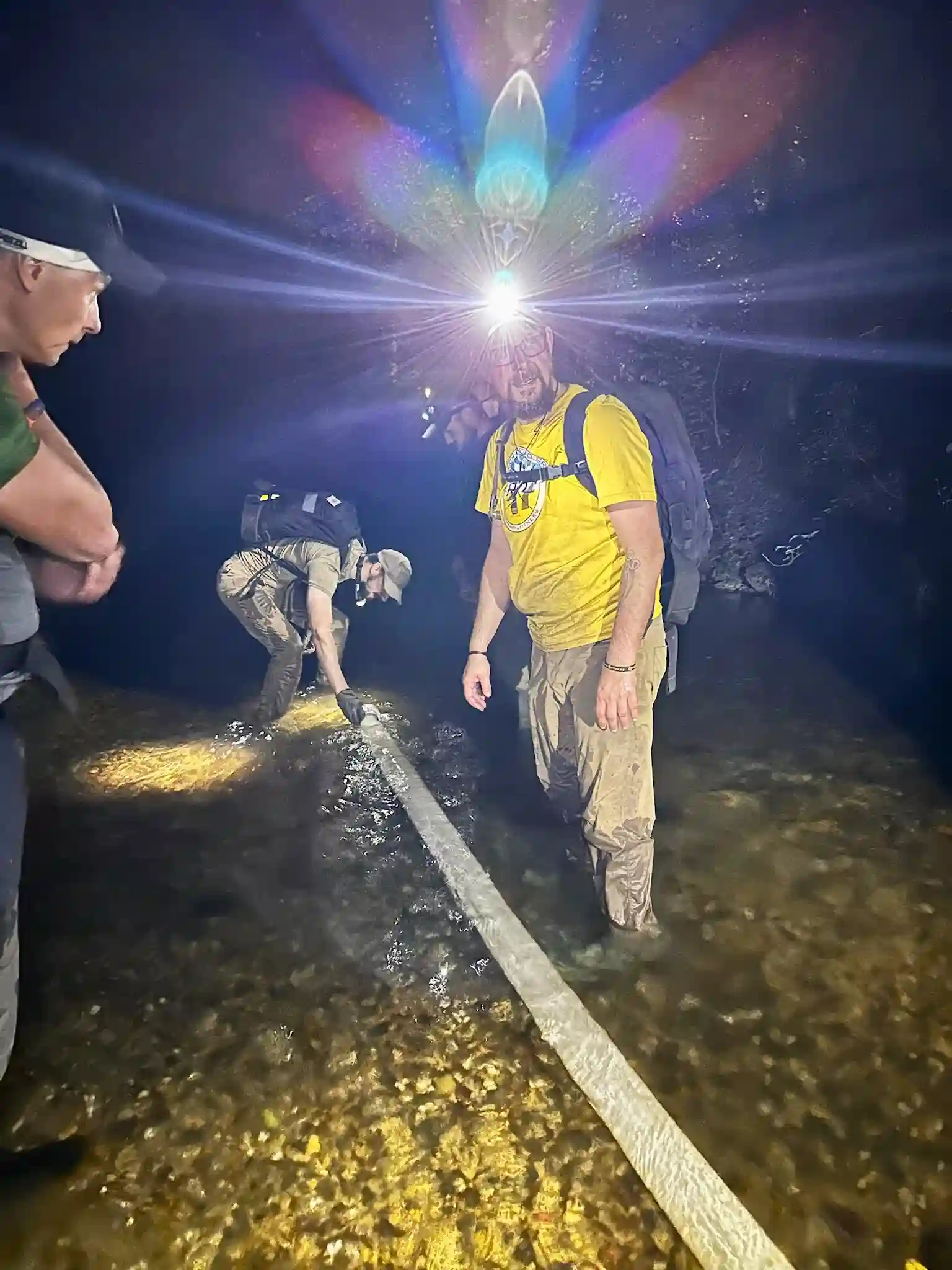 The author at the head of the fire hose trying to fill it.